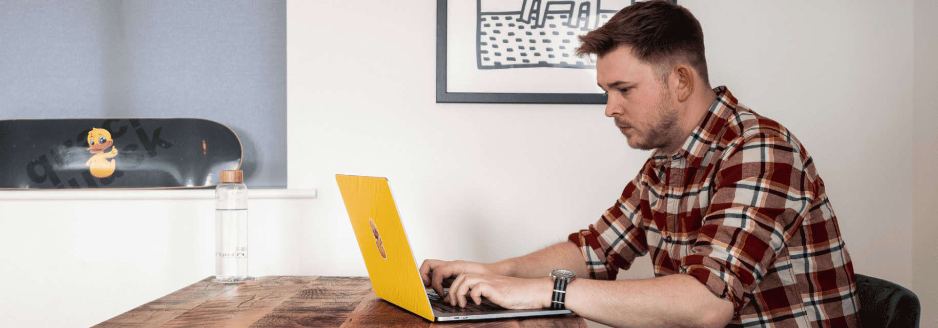 A man sitting at a desk using a laptop for web development in Hampshire.