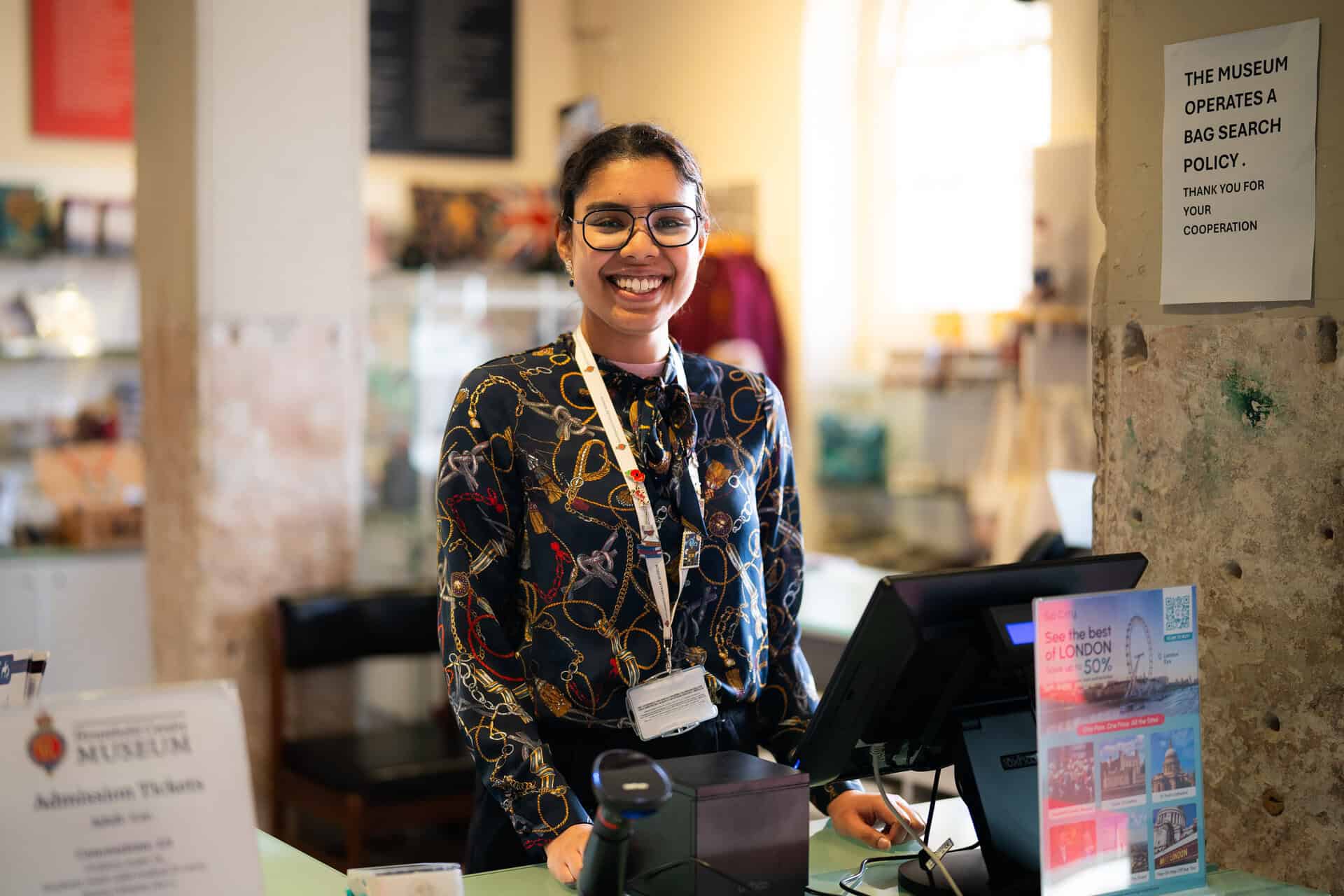 Charity staff at museum front desk — example of accessible website design.