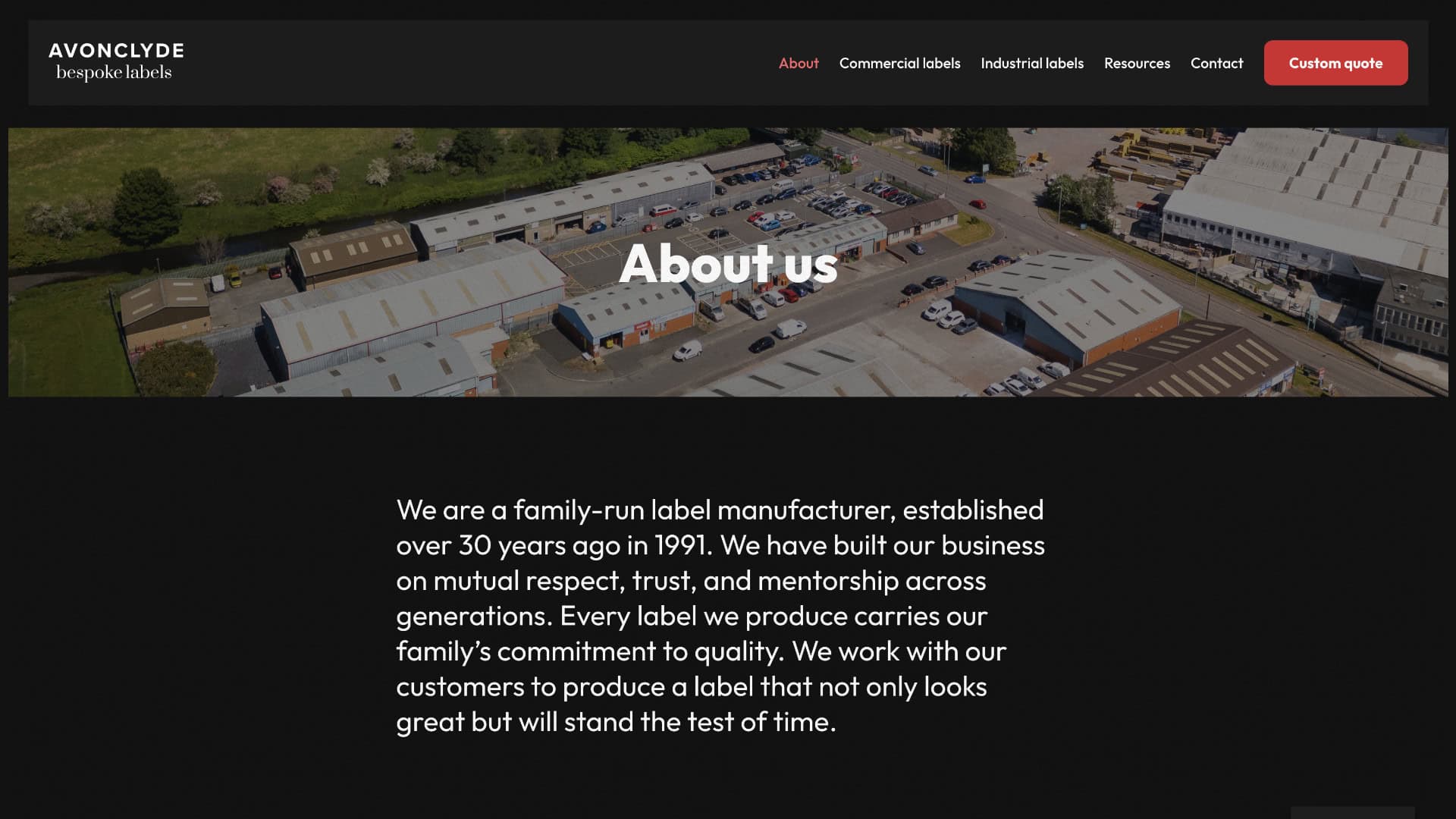 Aerial view of an industrial complex with buildings and vehicles, overlaid with the heading "About us" and text describing a family-run bespoke labels manufacturing business established in 1991. | Rubber Duckers